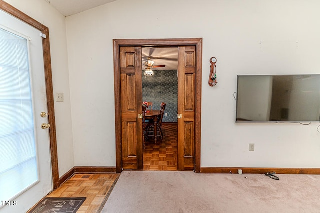 interior space featuring ceiling fan, light parquet floors, and lofted ceiling