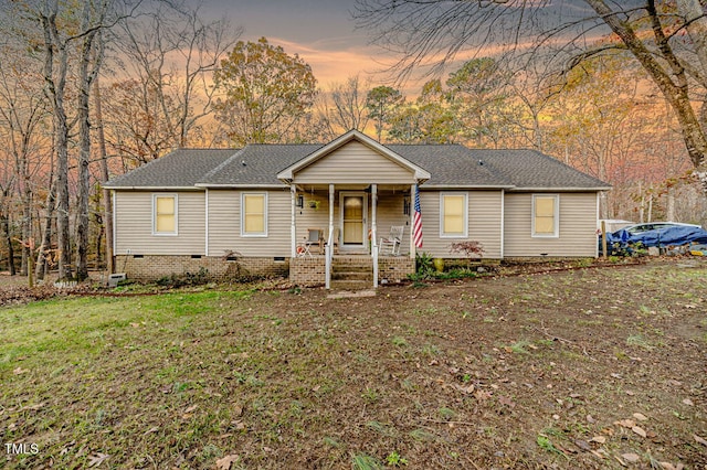 single story home featuring a lawn and covered porch