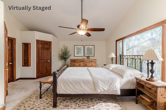 carpeted bedroom with ceiling fan and lofted ceiling