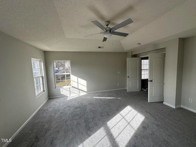 unfurnished bedroom featuring carpet flooring, ceiling fan, and a textured ceiling