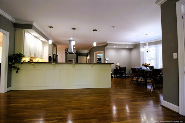 kitchen featuring island exhaust hood, kitchen peninsula, dark wood-type flooring, a notable chandelier, and white cabinets