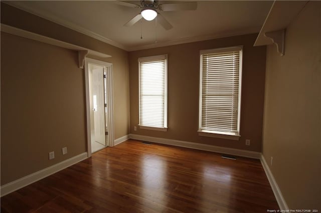 unfurnished room with ceiling fan, dark hardwood / wood-style flooring, and crown molding