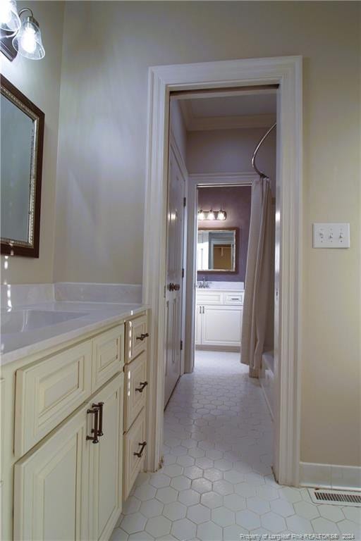 bathroom featuring tile patterned flooring, vanity, and shower / tub combo with curtain