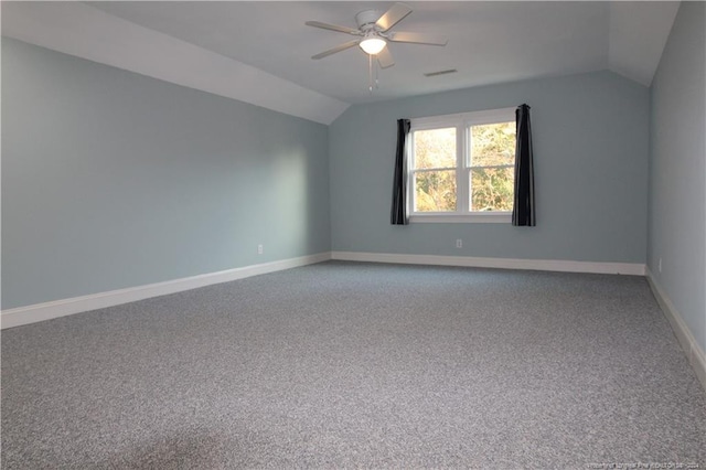 empty room featuring carpet, ceiling fan, and vaulted ceiling