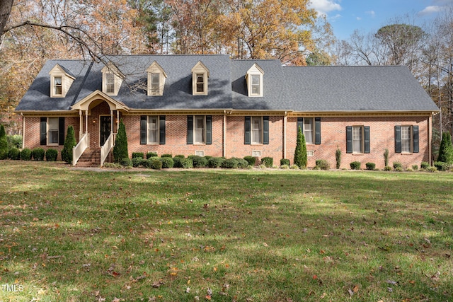 new england style home featuring a front yard