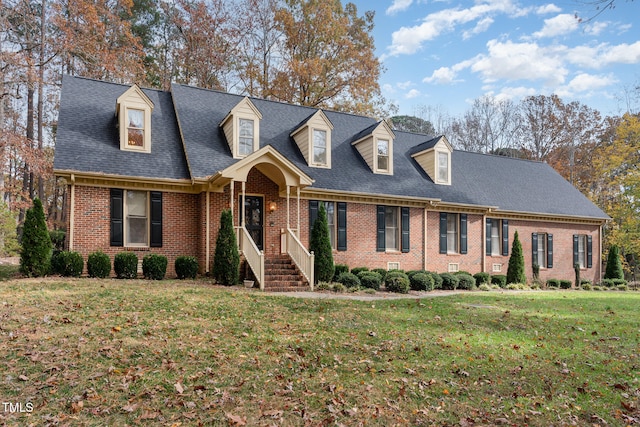 cape cod home with a front lawn