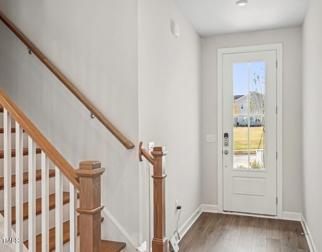 doorway with hardwood / wood-style flooring