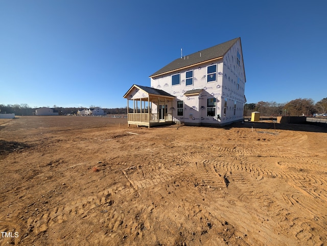 back of property with a rural view