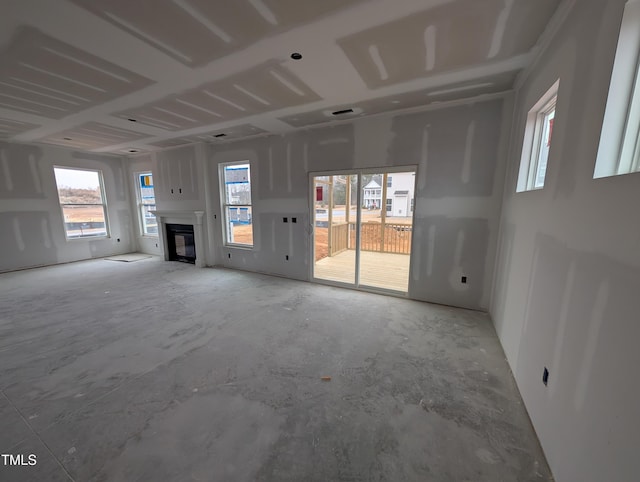 unfurnished living room with concrete floors