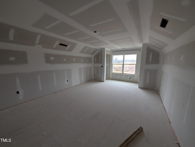 empty room featuring vaulted ceiling