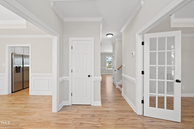 hallway featuring light hardwood / wood-style floors and ornamental molding