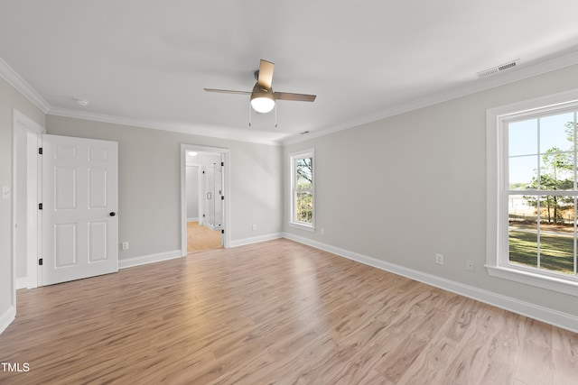 spare room featuring ceiling fan, ornamental molding, and light wood-type flooring