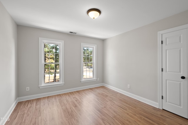 spare room with light hardwood / wood-style flooring