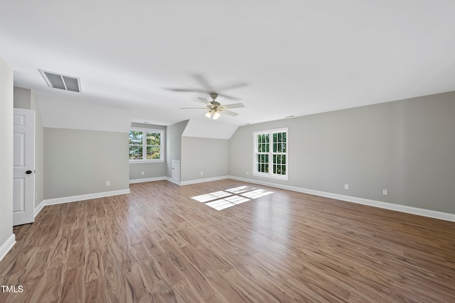 interior space featuring ceiling fan, plenty of natural light, wood-type flooring, and lofted ceiling