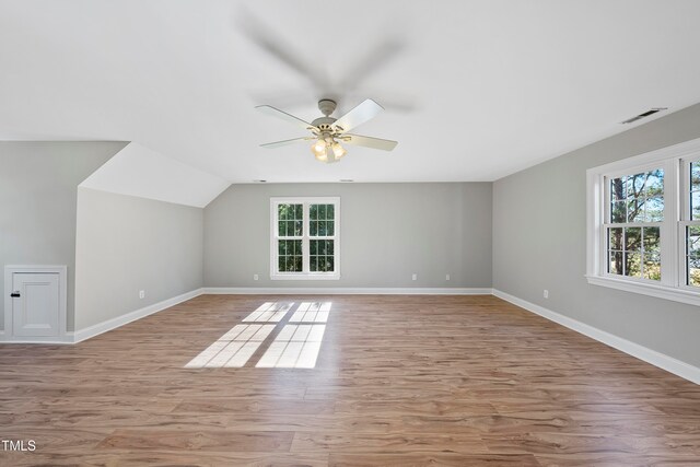 bonus room featuring vaulted ceiling, light hardwood / wood-style flooring, and ceiling fan