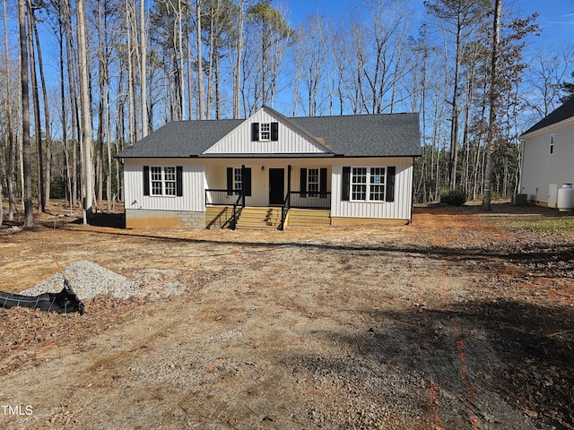 modern farmhouse style home with a porch and central air condition unit