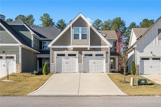 craftsman house with a garage and a front lawn