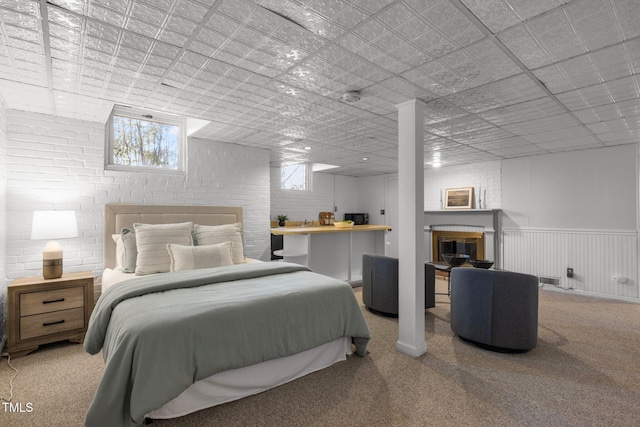 bedroom with brick wall and carpet