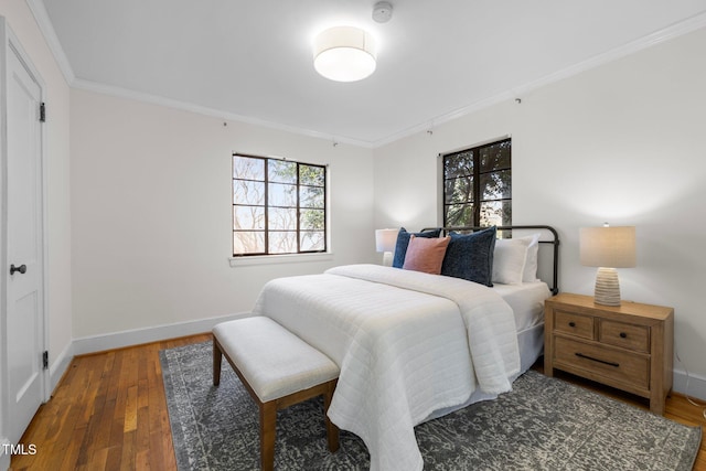 bedroom with dark hardwood / wood-style flooring and ornamental molding