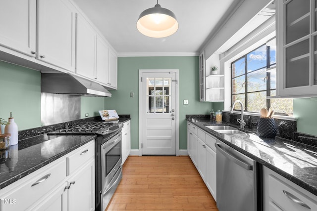 kitchen featuring white cabinetry, sink, dark stone countertops, hanging light fixtures, and stainless steel appliances