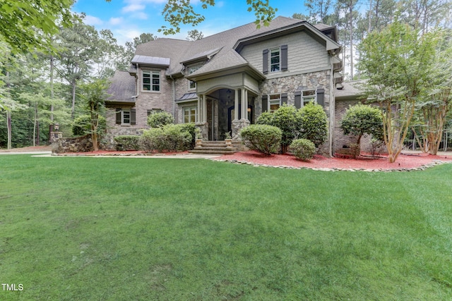 view of front of property featuring a sunroom and a front yard