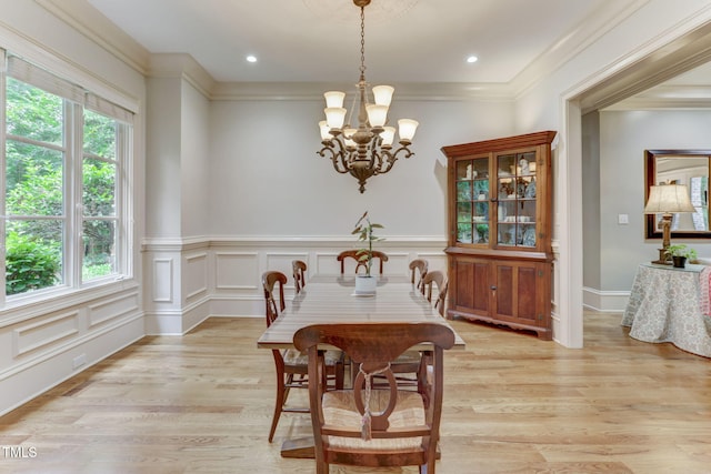 dining room with a chandelier, a wealth of natural light, and light hardwood / wood-style flooring