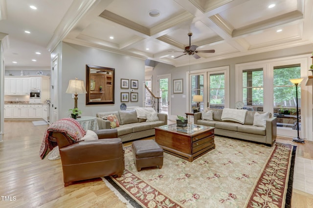 living room featuring beamed ceiling, crown molding, coffered ceiling, light hardwood / wood-style flooring, and ceiling fan