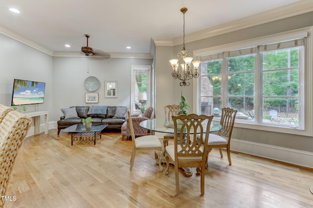 dining room with a chandelier, ornamental molding, and light hardwood / wood-style floors