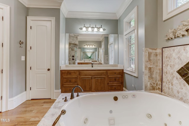 bathroom featuring tiled bath, a wealth of natural light, vanity, and crown molding