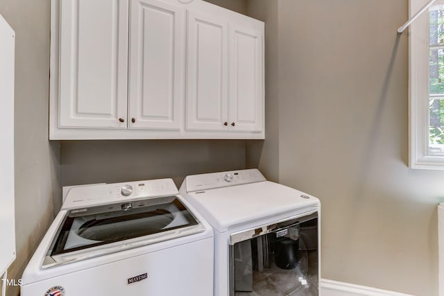 washroom featuring cabinets and washer and dryer