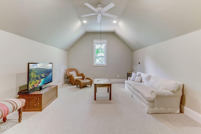 living room with ceiling fan, carpet floors, and lofted ceiling