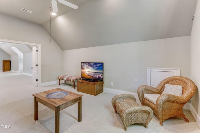 living area featuring ceiling fan, light colored carpet, and lofted ceiling