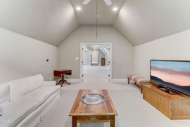 carpeted living room with ceiling fan and vaulted ceiling