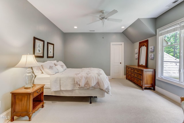 carpeted bedroom featuring ceiling fan, vaulted ceiling, and multiple windows