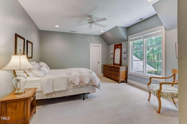 carpeted bedroom with ceiling fan and vaulted ceiling