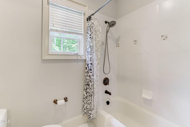 bathroom featuring toilet and shower / bath combo