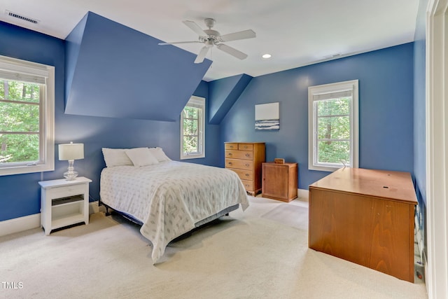 carpeted bedroom featuring ceiling fan, multiple windows, and lofted ceiling