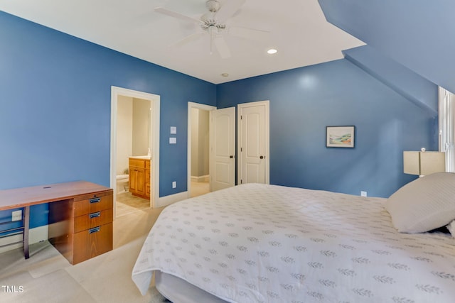 carpeted bedroom with ceiling fan and ensuite bath