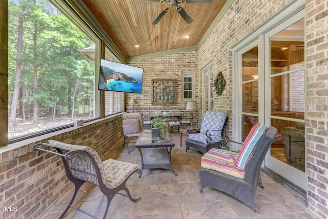 sunroom with ceiling fan, wooden ceiling, a healthy amount of sunlight, and vaulted ceiling