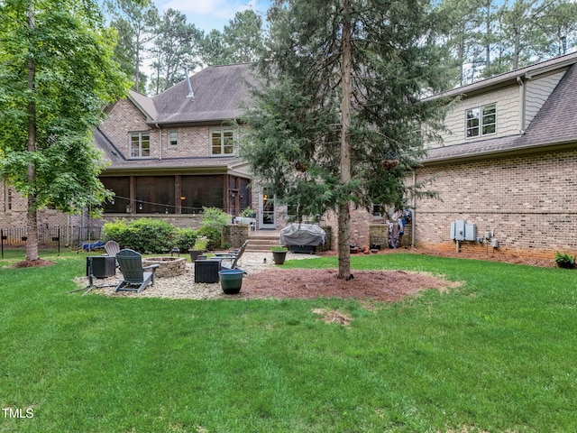 back of house with a sunroom and a lawn