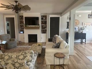 living room featuring ceiling fan and hardwood / wood-style flooring