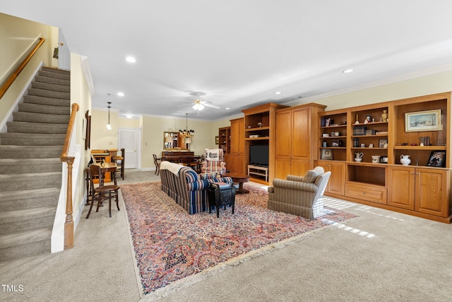 carpeted living room featuring ceiling fan and crown molding