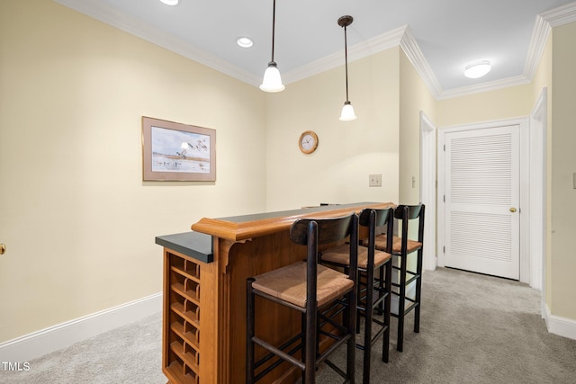 bar featuring carpet flooring, pendant lighting, and crown molding