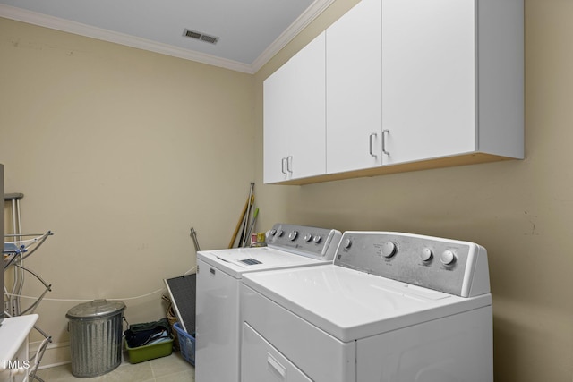 laundry room with washer and dryer, cabinets, ornamental molding, and light tile patterned floors