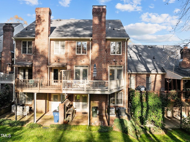 rear view of property featuring central AC unit and a patio