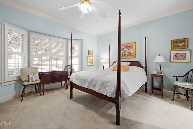 carpeted bedroom with ceiling fan and ornamental molding