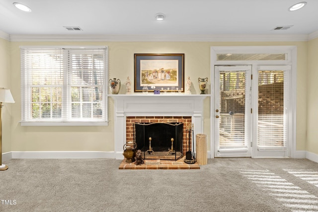 living room with carpet floors, a healthy amount of sunlight, and ornamental molding