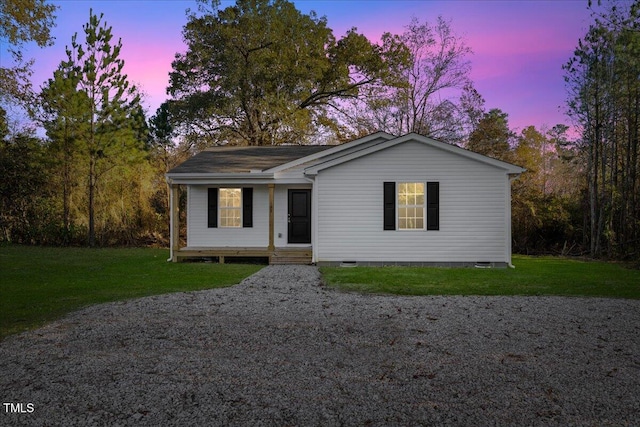 ranch-style home with a lawn