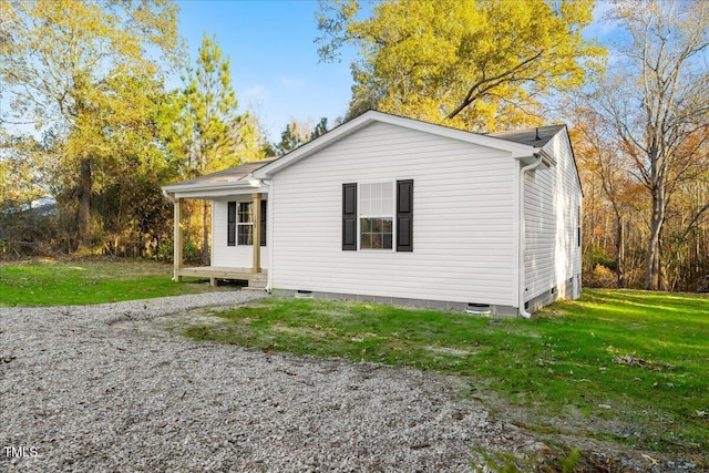 rear view of property with a yard and a porch