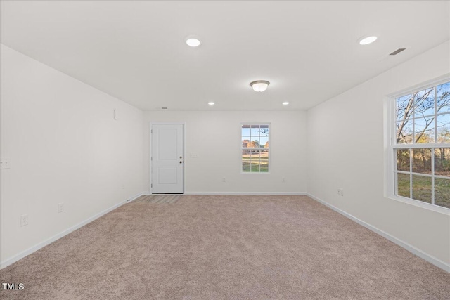 spare room featuring light colored carpet